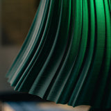 Pleat table lamp photographed in a styled interior.