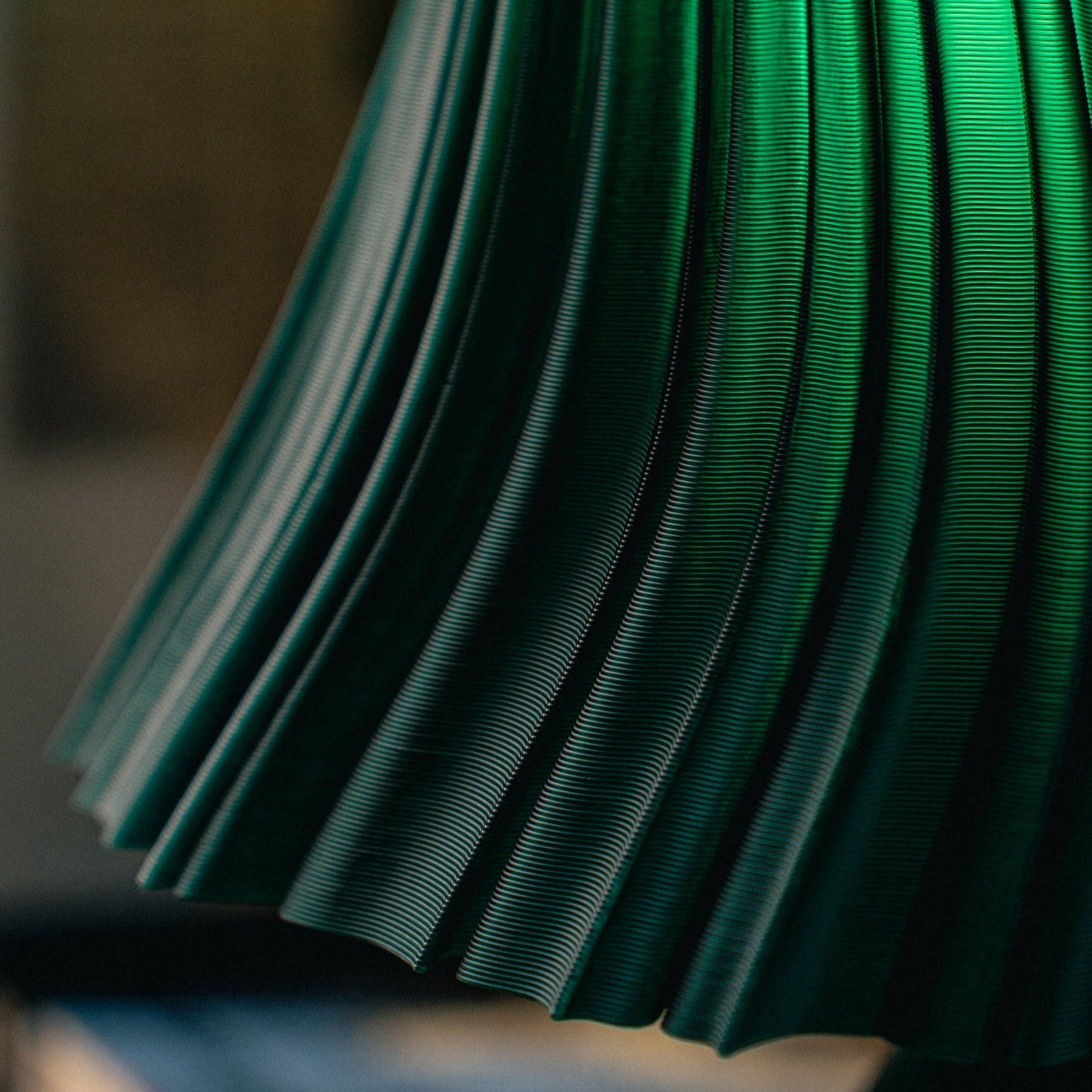 Pleat table lamp photographed in a styled interior.