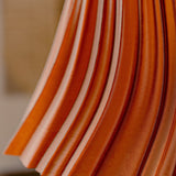 Pleat table lamp photographed in a styled interior.