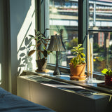 Pleat table lamp photographed in a home setting.