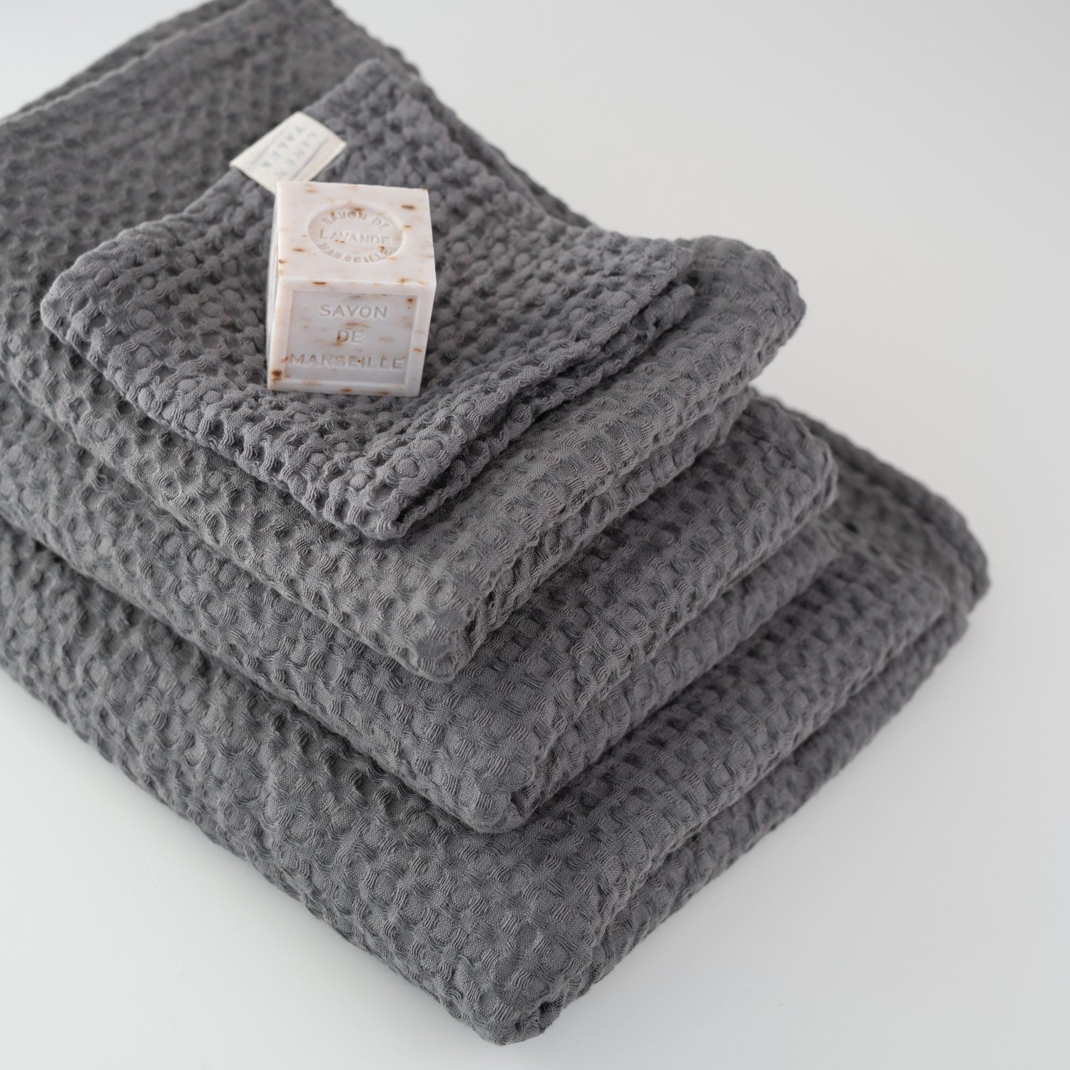 Dark grey honeycomb waffle towel texture close view