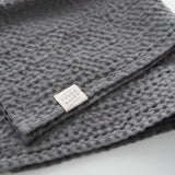 Dark grey linen-cotton towel folded for open shelf styling