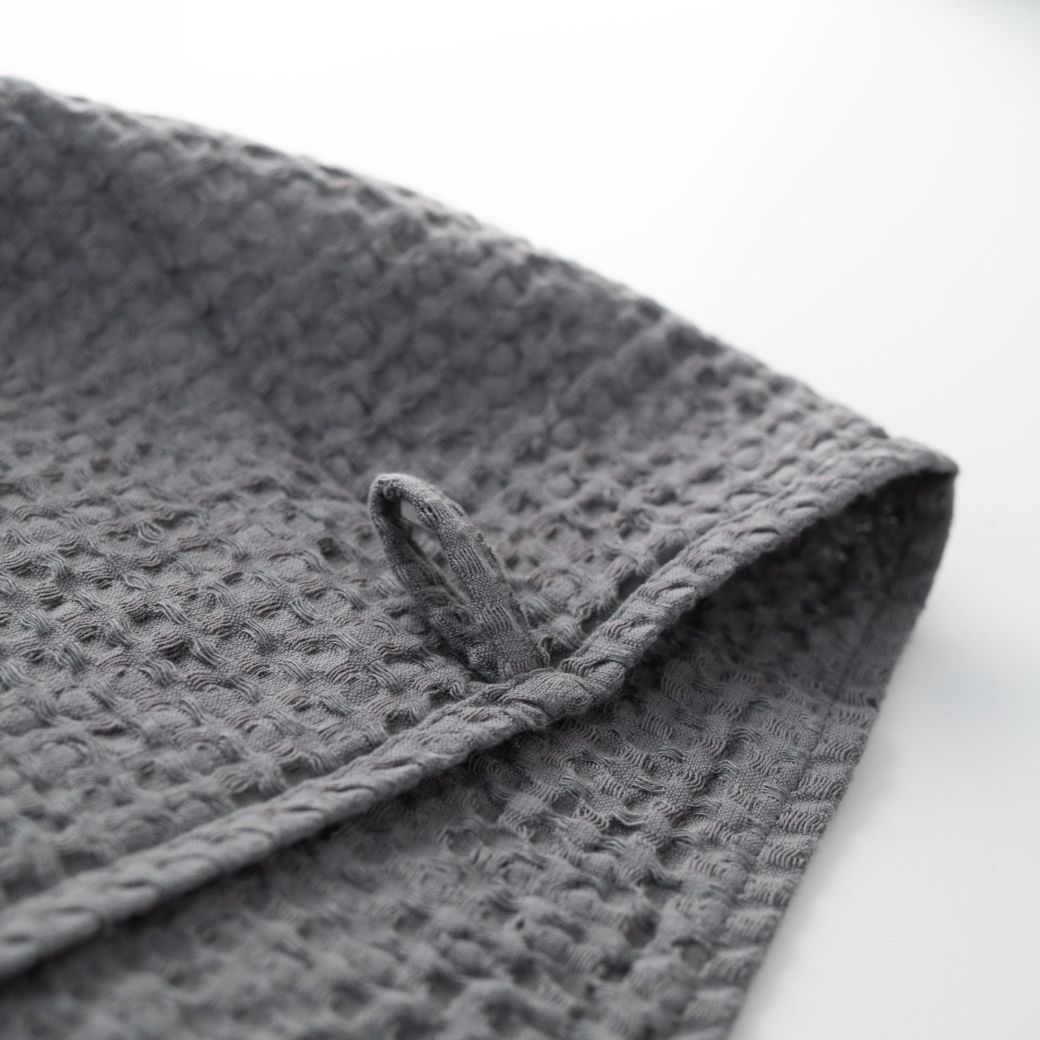 Waffle weave hand towel and bath textile in dark grey
