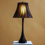 Pleat table lamp detail in a styled room.