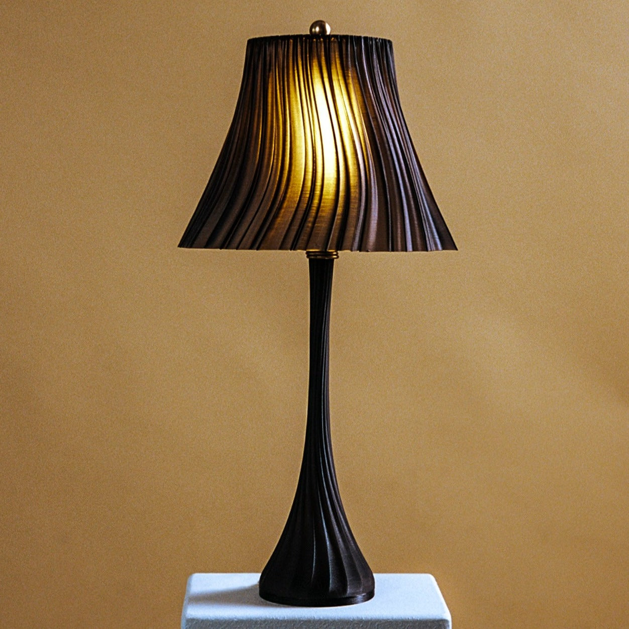 Pleat table lamp detail in a styled room.