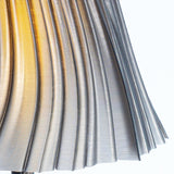 Pleat table lamp shown in a tall ambient-light setting.