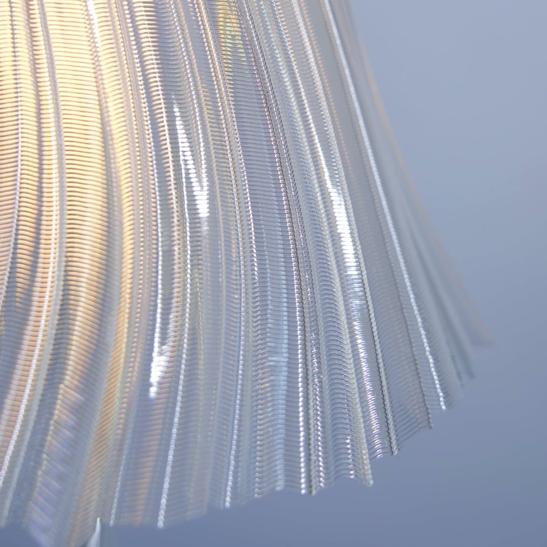 Pleat table lamp shown in a tall ambient-light setting.