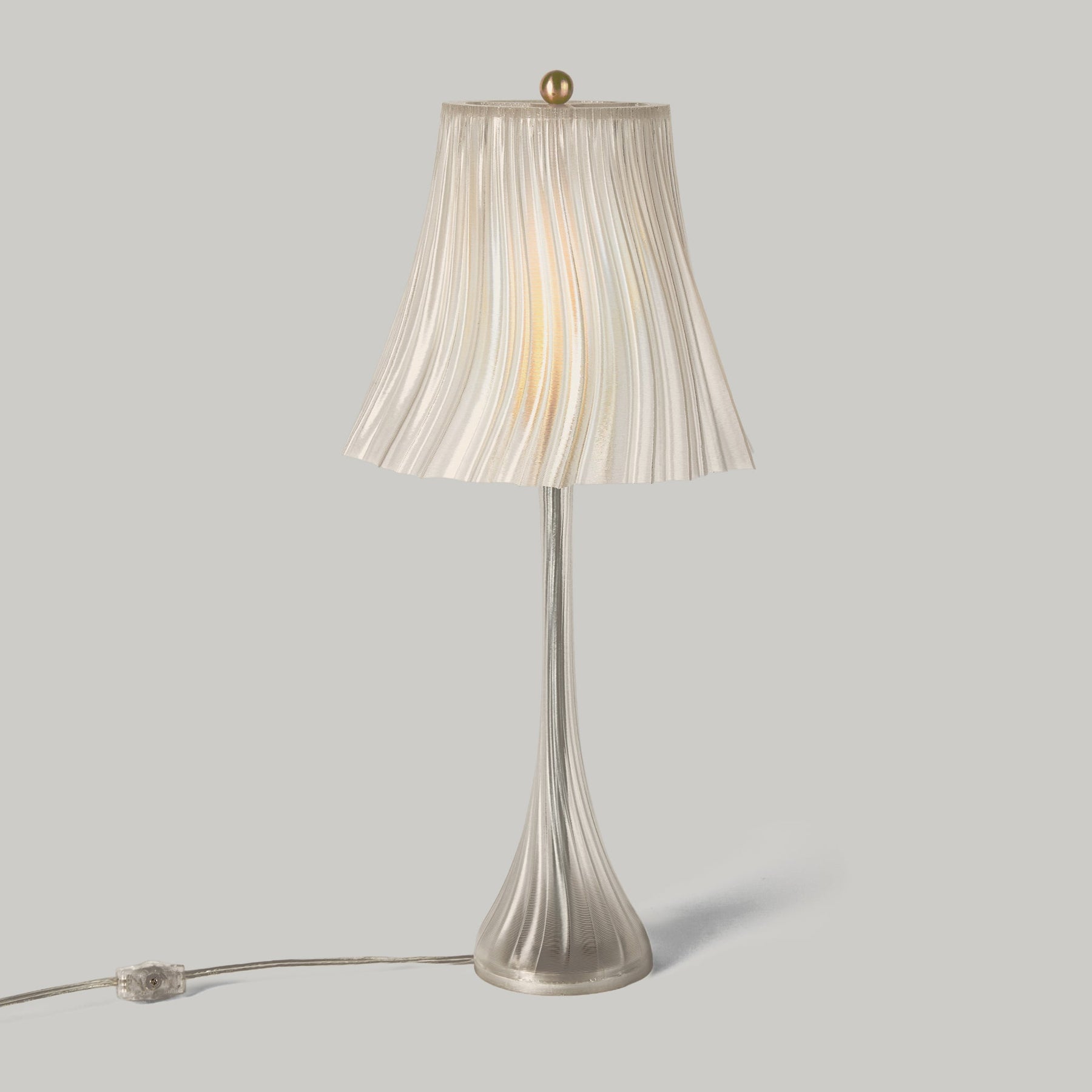 Clear Pleat table lamp isolated product view.
