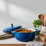 Blue enamel cast iron Dutch oven on kitchen counter